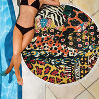 Round beach blanket with black base, bold animal-print design, and white fringe border