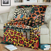 Colorful wild animal print blanket with bold geometric borders, laid over a cream armchair