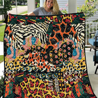 Wild animal print quilt with zebra, giraffe, and cheetah patterns in multicolor on black