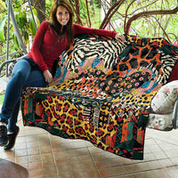 Folded wild animal skins quilt with zebra, giraffe, and cheetah patterns in bright colors