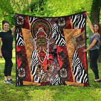 African motif quilt featuring zebra stripes, patchwork triangles, and a central ceremonial face.