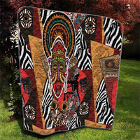 African motif quilt with bold zebra pattern and colorful face medallion, red and tan panels.