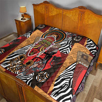 African motif quilt on bed with zebra stripes, patchwork triangles, and colorful face design.