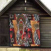 African motif quilt hanging on barn wall with zebra stripes and central colorful face motif.