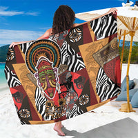 Patterned African-style sarong with black zebra stripes, face motif, red, brown, and gold panels