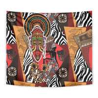Close-up African tapestry with central ornate mask face and surrounding animal patterns