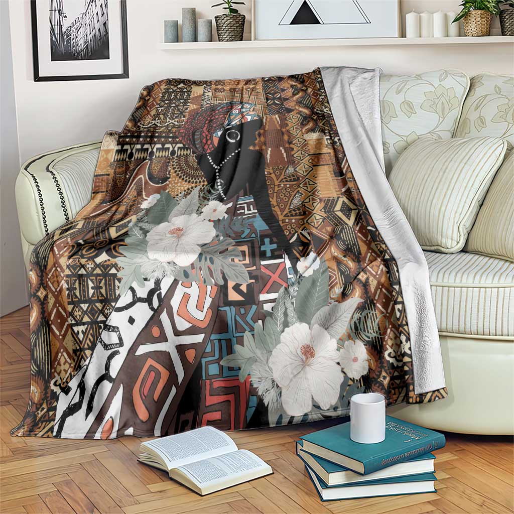 Brown tribal blanket with black woman silhouette, geometric motifs, and white flowers.