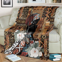 Brown blanket draped on couch, black woman silhouette, geometric designs, and white floral print.
