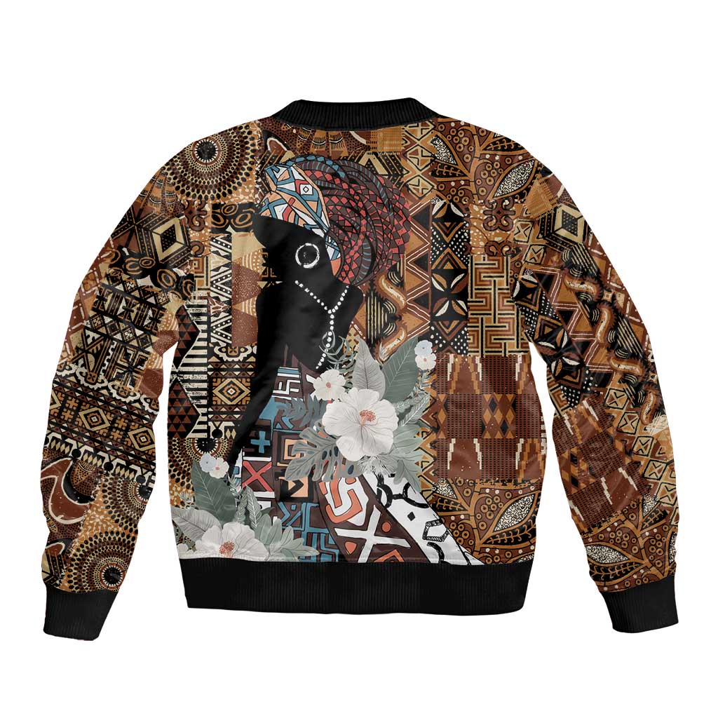 Brown bomber jacket with large central graphic, black ribbed cuffs and hem, front zipper