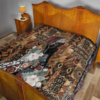 Brown tribal quilt laid on bed, geometric medallion blocks, black face figure, white florals