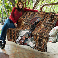 Brown quilt with woven-like geometric motifs, black face graphic, white flower applique, trim