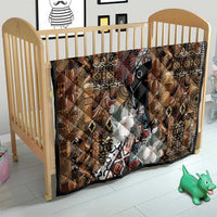 Brown tribal quilt in a crib, geometric pattern with black face and white floral applique
