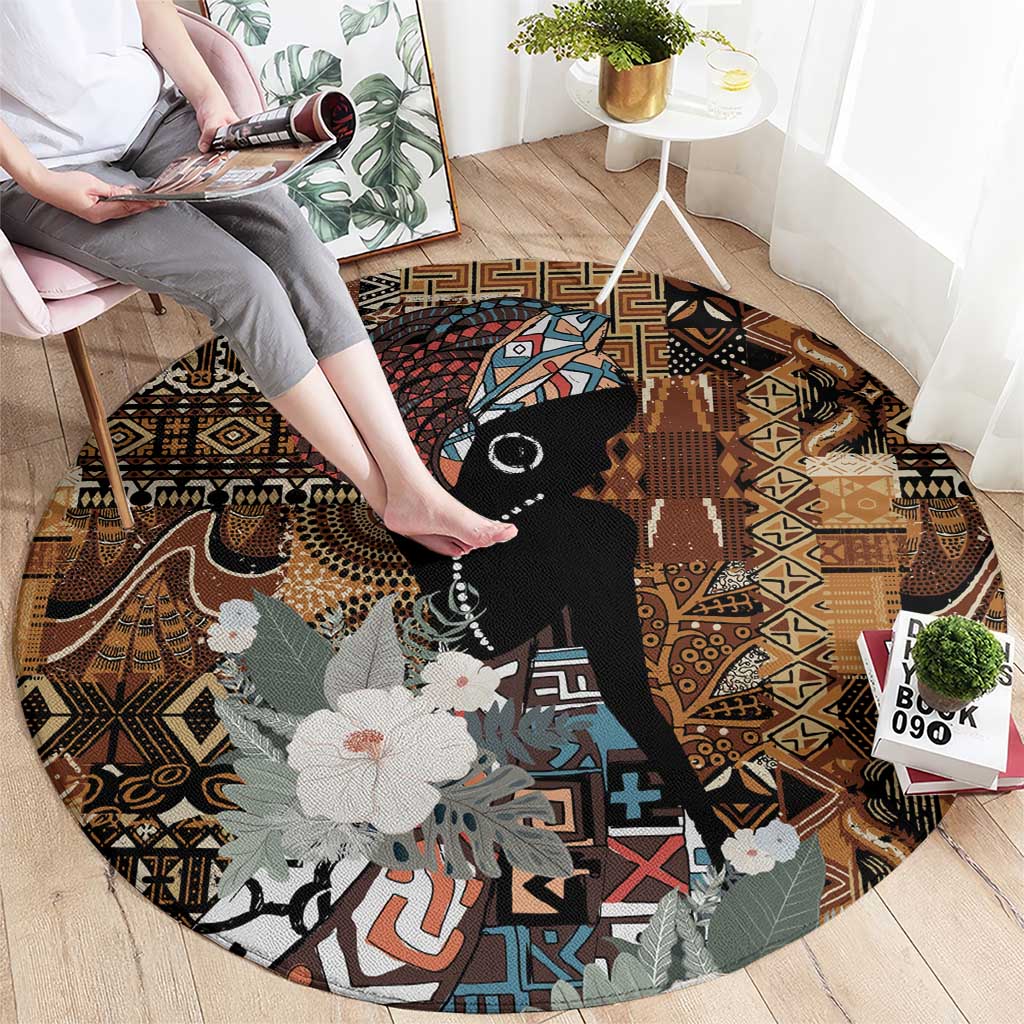 Round rug with tribal geometric print, black portrait with floral accents in brown