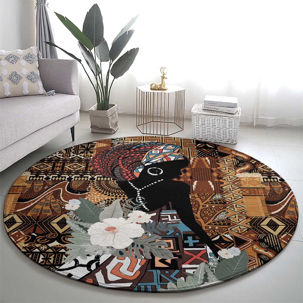 Round tribal rug showing black portrait with colorful geometric background and gray flowers