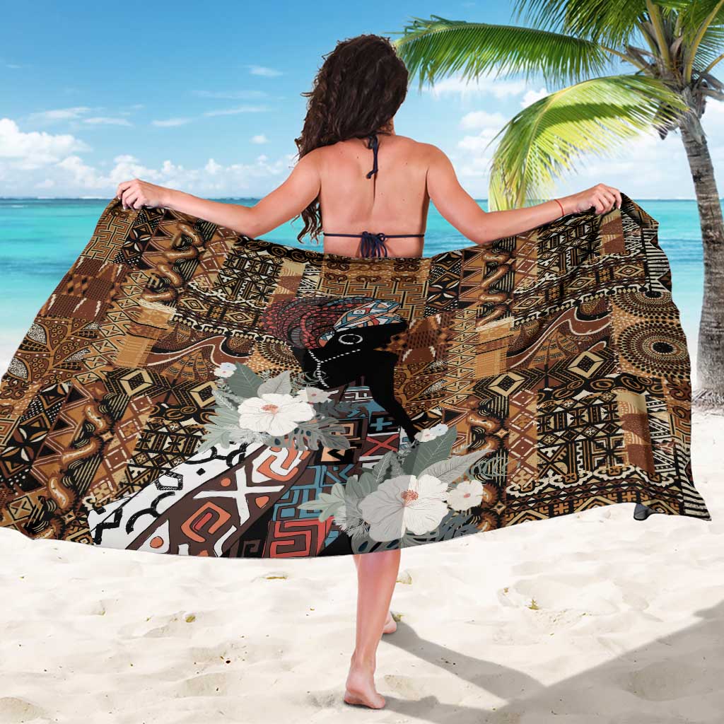Black and brown African patterned sarong wrap draped open, floral and animal motif