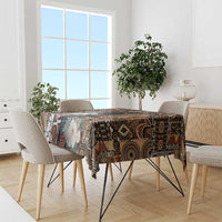 Rectangular tablecloth draped on dining table, tribal geometric pattern in dark brown