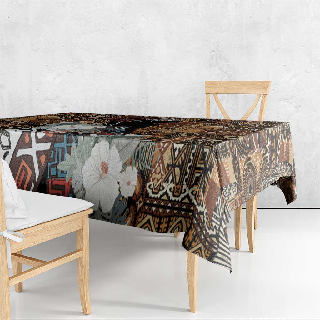 Rectangular tablecloth over bench table with dark geometric tribal pattern and floral print