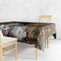 Rectangular tablecloth over bench table with dark geometric tribal pattern and floral print