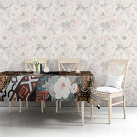 Rectangular tablecloth on long dining table with dark tribal pattern and large floral motifs