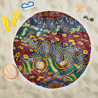Round beach blanket with fringed edge, colorful African animal-skin pattern in red, blue, green