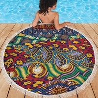 Round beach blanket with tassel fringe, vibrant African animal-skin pattern in blue and red