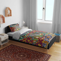 Red duvet set on bed with two pillowcases, animal-skin style pattern in blue and green
