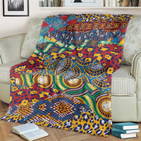 Multicolor animal-skin pattern blanket with vibrant swirls and geometric borders on a couch