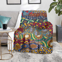 Multicolor animal-skin pattern blanket covering a chair, with teal, yellow, and red swirls