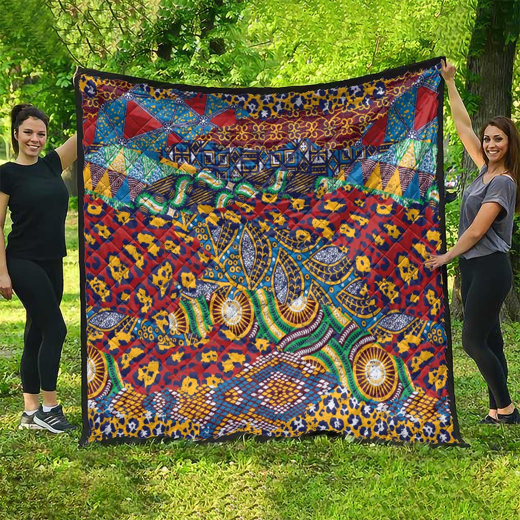 Traditional-style quilt showing vivid animal-skin and geometric patterns, red and teal blue.