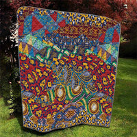 Vibrant red, blue, and green quilt with detailed ornate animal-skin inspired center design.