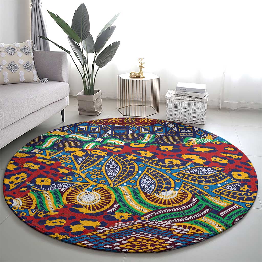 Round tribal rug with bold blue center medallion pattern, red ground and green swirls