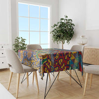 Animal-skin pattern tablecloth in blue, yellow, red, and green on a dining table