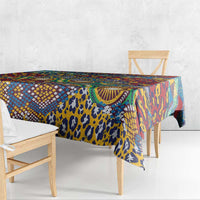 Animal-skin patterned tablecloth with colorful geometric details draped over a table