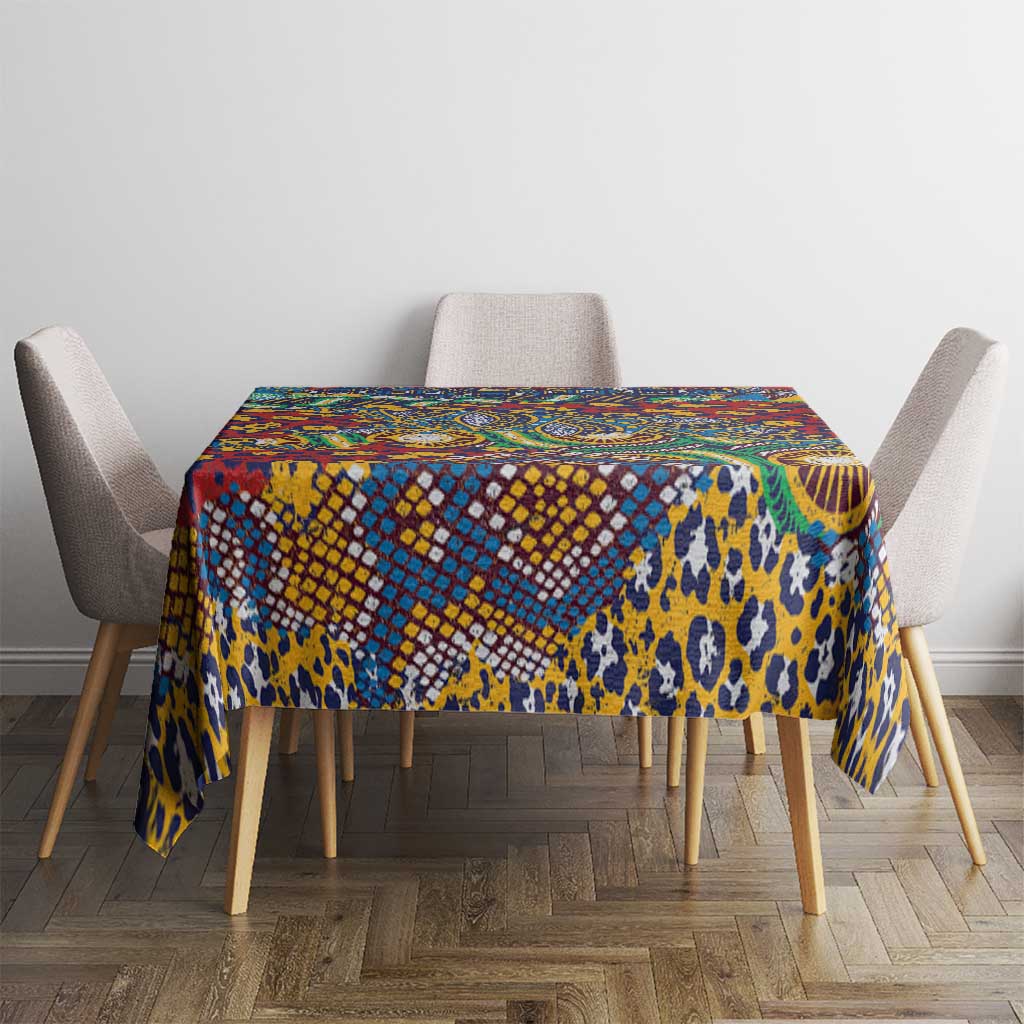 Blue animal-skin print tablecloth with multicolor geometric pattern across the top