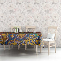 Animal-skin motif tablecloth with blue, yellow, red, and green on a dining table