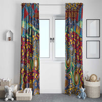 Pair of colorful patterned window curtains on a white wall above the floor