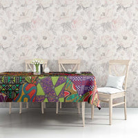 Multicolor ethnic geometric motif tablecloth on a long dining table, decorative print
