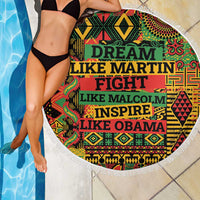 Round beach blanket with white fringe, colorful print and large “DREAM LIKE MARTIN…” text