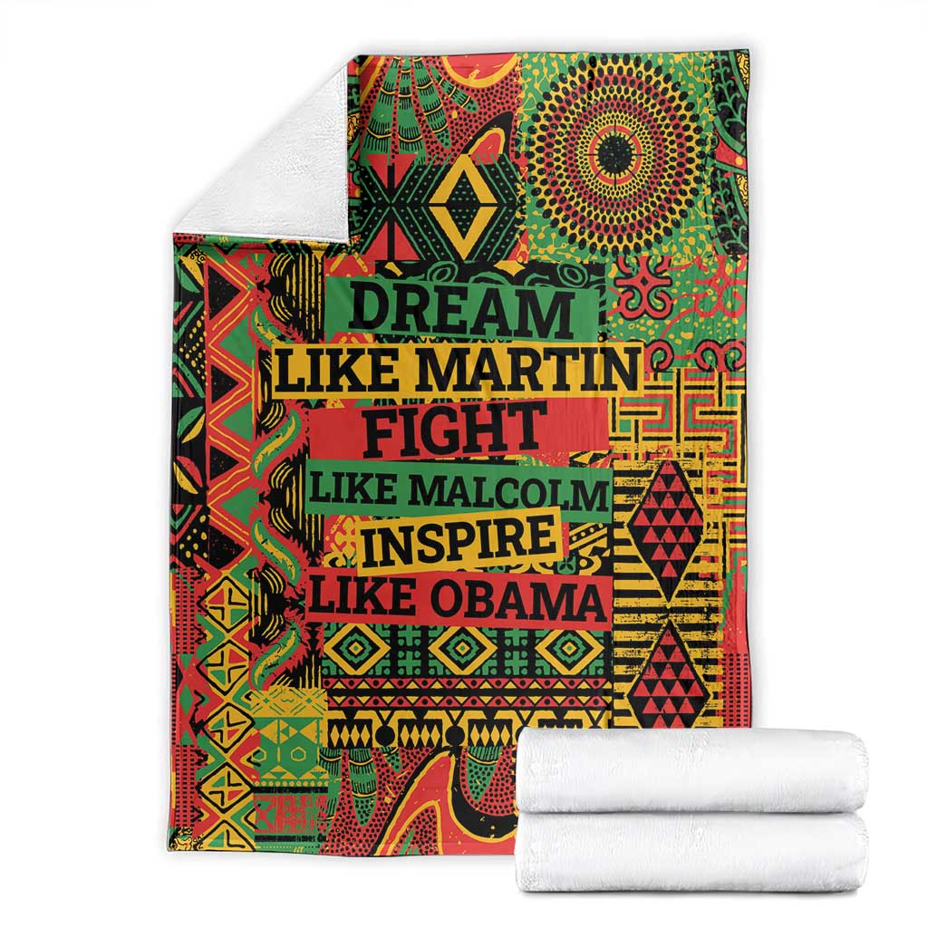 Folded patterned throw blanket with multicolor text design and stacked white towels
