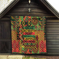 Rectangular quilt with vibrant geometric designs and bold “DREAM” text blocks.