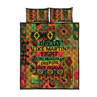 Quilt bed set with bold stacked text and bright geometric pattern; two matching pillow shams
