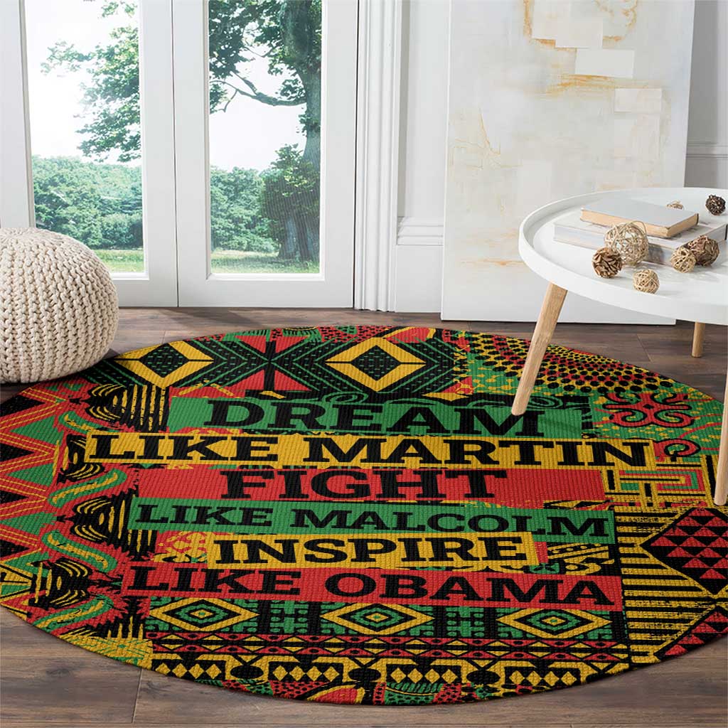 Round area rug with colorful geometric motif and prominent teal slogan text on black