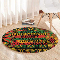 Round area rug with multicolor geometric border and stacked text reading across the center