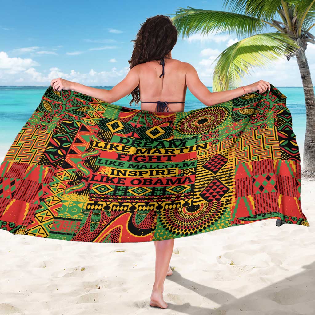 Colorful geometric sarong with multicolor text panels, worn as a wide wrap