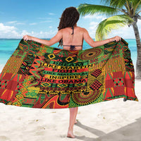 Colorful geometric sarong with multicolor text panels, worn as a wide wrap