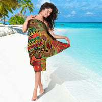 Printed sarong with geometric shapes and bold text, gathered at the waist