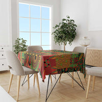 Colorful patterned tablecloth draped over dining table in green, red, yellow, black