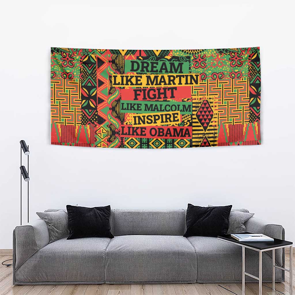 Colorful patterned wall tapestry above a gray sofa with dark pillows
