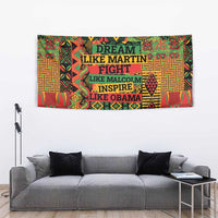 Colorful patterned wall tapestry above a gray sofa with dark pillows