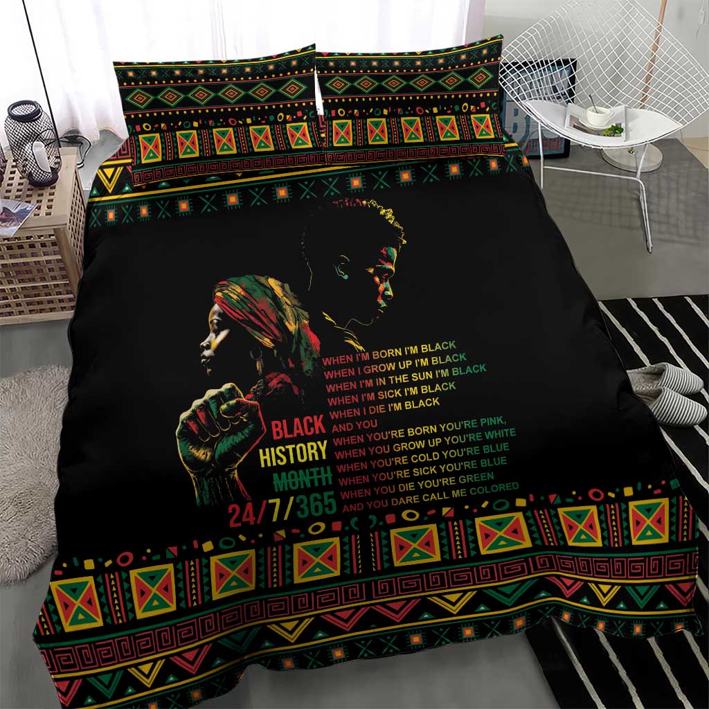 Black duvet cover with portrait graphic and multicolor text, framed by tribal border